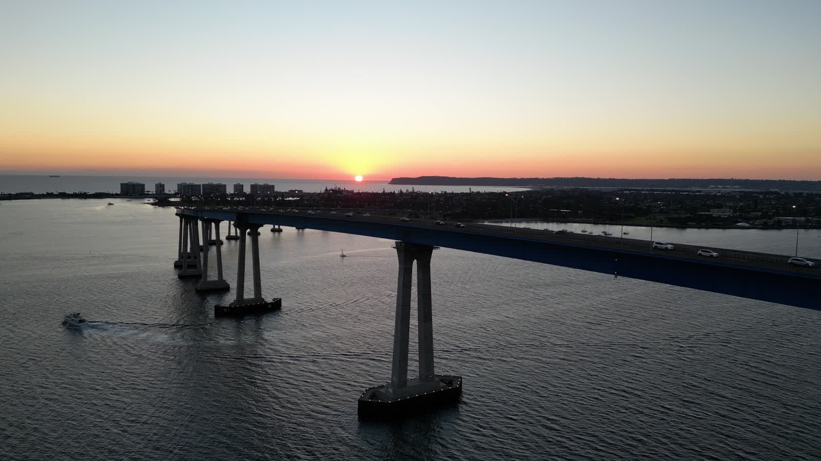 Coronado Bridge curving across San Diego Bay at sunset